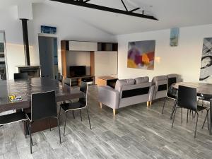a living room with tables and chairs and a couch at La maison d'Ilaude de 7 à 14 personnes in Talmont-Saint-Hilaire
