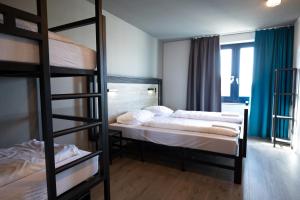 Postel nebo postele na pokoji v ubytování a&o Rotterdam City