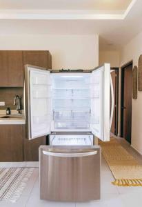a kitchen with an open refrigerator in the middle at Peaceful Villa W Ocean View Rooftop in Punta Sur in Isla Mujeres