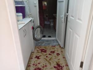 a bathroom with a washing machine on the floor at Bolu dağ evi at yaylası 