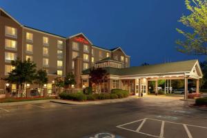 a hotel with a parking lot in front of it at Hilton Garden Inn Charlotte North in Charlotte