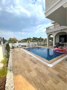 a swimming pool on the roof of a house at Villa white in Antalya