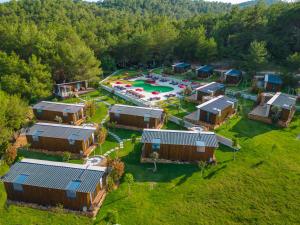 an aerial view of a resort with a pool and a playground at Mossa Afkule Kayaköy in Fethiye