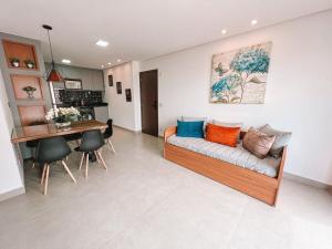 a living room with a couch and a table at Citizen Bueno by Marzani Host in Goiânia