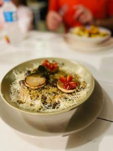 a bowl of food with rice and fruit on a table at Pousada PARAÍSO 26 in Imbituba