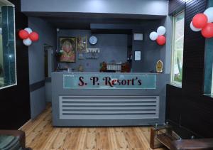 a restaurant with a s p q records counter with red balloons at Wayfare SP Resort in Panvel