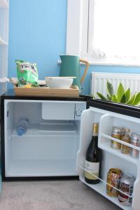 an open refrigerator with a bottle of wine at Studio Pillo Hammersmith in London