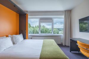 Postel nebo postele na pokoji v ubytování Amrâth Airport Hotel Rotterdam