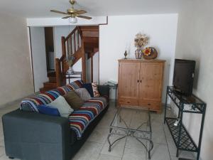 a living room with a couch and a tv at La Croisée Des Chemins in Maisonnais-sur-Tardoire