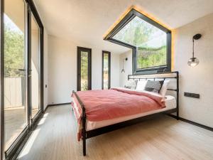 a bedroom with a bed with a large window at Mossa Afkule Kayaköy in Fethiye