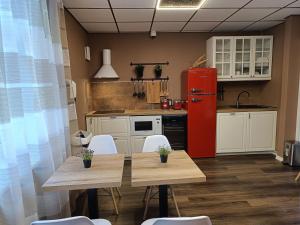 a kitchen with a table and a red refrigerator at ApartHOTELL in Narva