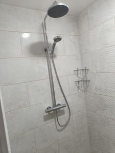 a shower with a shower head in a bathroom at APARTHOTEL in Narva