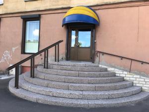 a set of stairs in front of a building with a door at APARTHOTEL in Narva