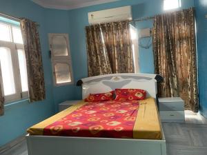 a bedroom with a bed in a blue room at MOON HAVELI in Bikaner