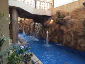 a water slide in a mall with two fountains at The GlassHouse Pool in Cairo