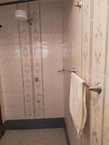 a bathroom with a shower with a towel at Beautiful spacious room in Nairobi