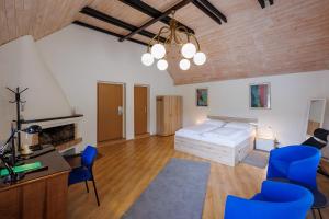 a bedroom with a bed and a desk and chairs at Pension U Golfu Cihelny in Karlovy Vary