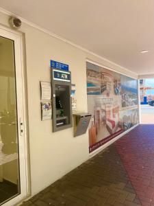 an atm machine on the wall of a building at Dushi Apartments in Willemstad