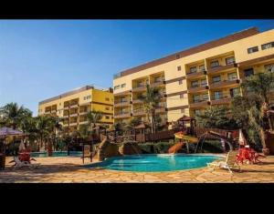a resort with a swimming pool and a playground at BARRETOS COUNTRY in Barretos