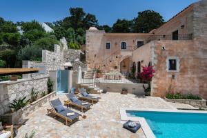 a house with a swimming pool next to a building at Butterfly, a historical villa with pool & hot tub! in Arménoi