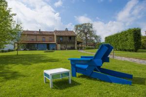 a blue chair and a table in front of a house at La Ermita de Deva in Deva