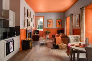 a kitchen and living room with an orange ceiling at Meikleour Arms Hotel & Restaurant in Meikleour