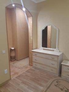 a bedroom with a dresser and a mirror at Celebrity in Kamianets-Podilskyi