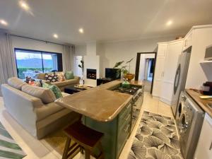 a kitchen and living room with a couch and a stove at WildCroft 20 in Balgowan