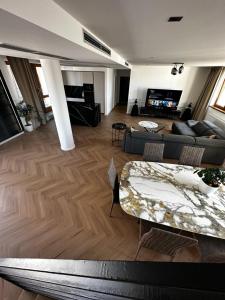 a living room with a couch and a table at Luxury PENTHOUSE at the Historical Centre with free parking in Bratislava
