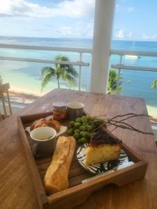 un piatto di cibo su un tavolo con vista sull'oceano di Only4View rooftop Sainte-Anne a Sainte-Anne