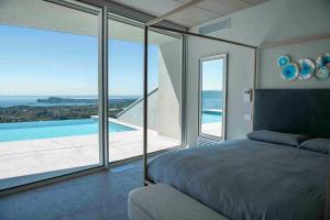 a bedroom with a bed and a view of a pool at Infinity Villa Salò in Salò +21 photos