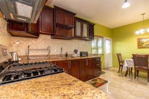 a kitchen with a stove and a counter top at J&R Sunshine Retreat in Spanish Town