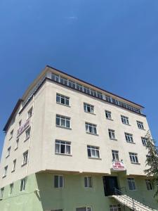 a tall building with a blue sky in the background at KALECİK OTEL in Kalecik