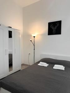 a bedroom with a bed with two towels on it at Dolce Vita House in Budapest