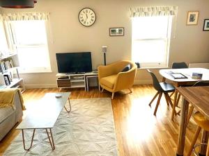 a living room with a couch and a tv at North Sea View Apartment in Scarborough