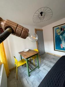 a room with a table and a telescope at Art Apartments Govora Cluj in Cluj-Napoca +23 photos