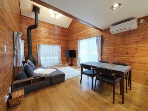 a living room with a couch and a table at HARUNA WING - Vacation STAY 26974v in Tsumagoi