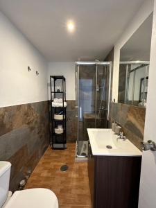 a bathroom with a shower and a sink and a toilet at Las Americas Tenerife in Arona