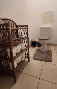 a bathroom with a toilet and a rack of toilet paper at appartement 2 pièces 5min gare val d'Europe parking inclus in Montévrain