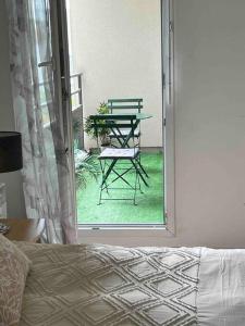 a patio with a table and a chair in a room at appartement Disneyland paris val d Europe la vallée village parking 600m gare RER in Montévrain