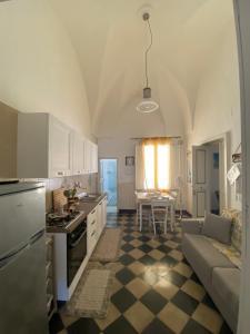 a kitchen and living room with a couch and a table at La chiccara del Bar Natale in Nardò
