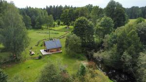 una vista aerea di una casa in mezzo a un campo di Salmiņu Pirtsmāja ar relaksējošu baļļu a Pastva Barbern