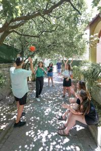a group of people playing with a frisbee at Los Mochileros Hostel - Age Limit 18-28 in Naples