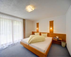 A bed or beds in a room at Soliva Hotel & Apartments