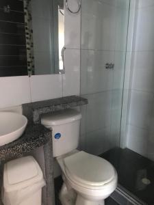 a bathroom with a white toilet and a sink at Hotel Colonial - Salamina Caldas in Salamina