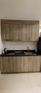 una cocina con armarios de acero inoxidable y fregadero en 2 Bedroom with Balcony/ Family Room en Manila