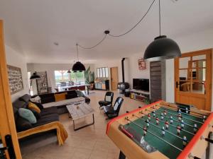 a living room with a pool table in it at Villa spacieuse Piscine, terrain de petanque in Villeveyrac