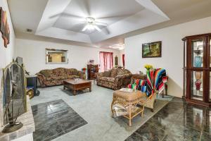 a living room with couches and a ceiling fan at Remote Pet-Friendly Harlingen House! in Harlingen
