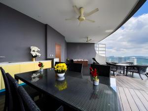 a dining room with a table with flowers on it at Vortex Klcc Penthouse Twins Tower View in Kuala Lumpur