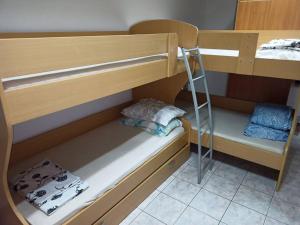 a bunk bed with a ladder on the bottom bunk at Room 400 m from the beach in Izola